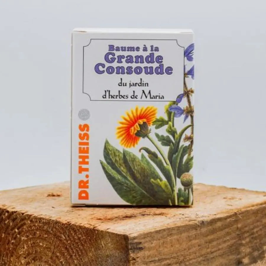 Un Baume à La Grande Consoude posé sur un bout de canapé en bois