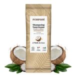 Un stick de 25 grammes de Shampoing en poudre à diluer Nourrissant parfum Coco de la marque Pimpant , posé entre deux noix de coco