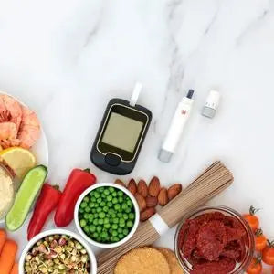 Lecteur de glycémie entouré de légumes et d'aliments à index glycémique bas