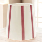 Un Brûle Parfum pour cire parfumée Stripes Red de Scentchips posé sur une table en bois, vue de dos