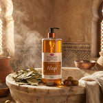 Une bouteille de savon d'alep liquide de la marque Emma Noël posée dans un hamam