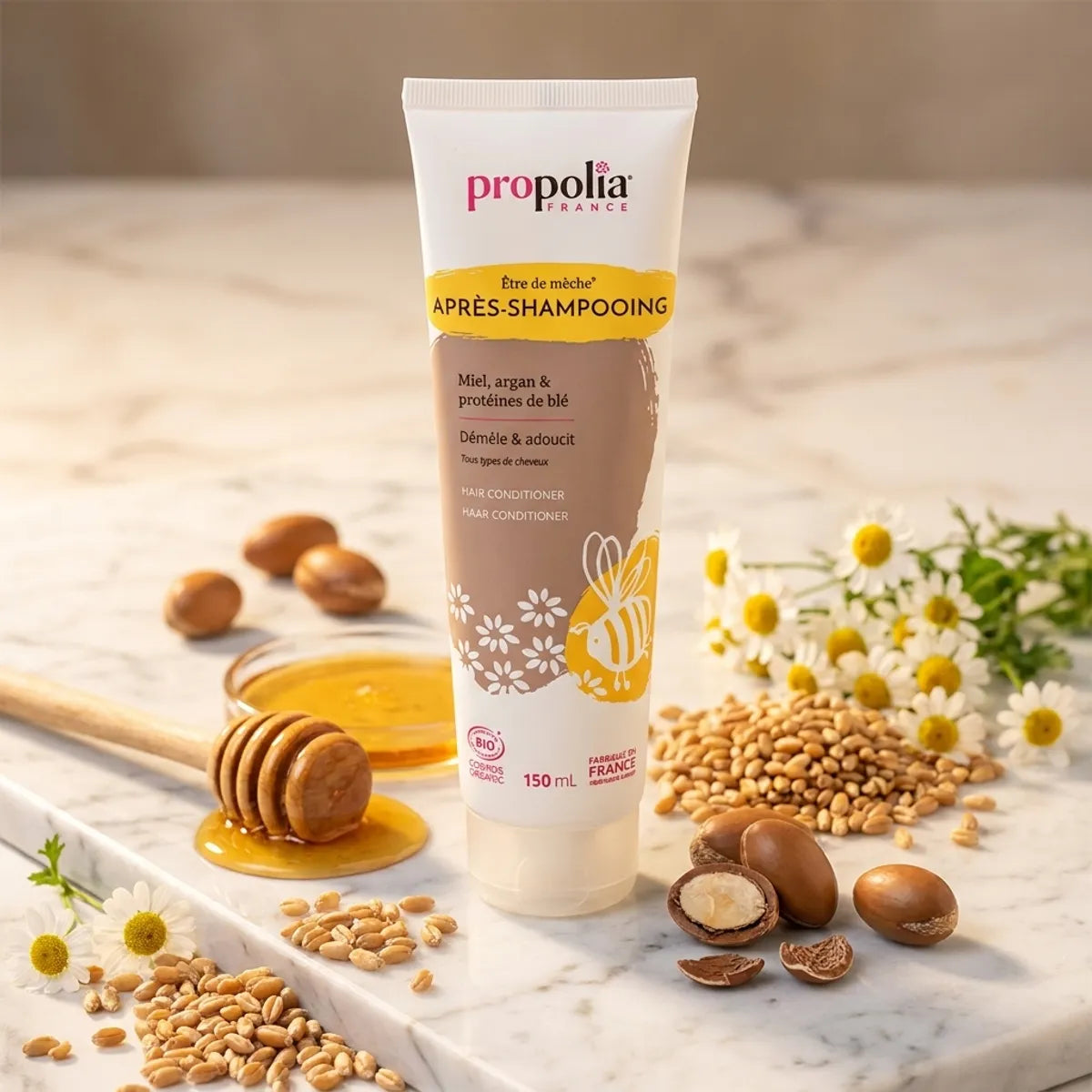 Après-shampoing bio Propolia 150ml miel argan blé sur marbre avec ingrédients naturels