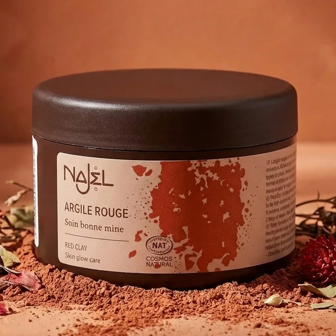 Argile rouge Najel 150g en poudre avec pot et poudre dispersée sur surface terracotta