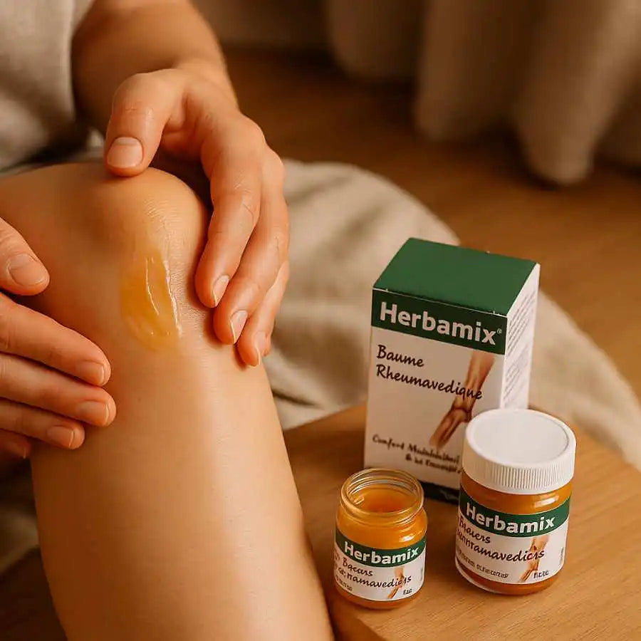 Photo d'une personne en train d'appliquer du baume rheumavedic de la marque Herbamix sur son genou
