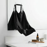 Bavoir à barbe noir avec ventouses fixé au miroir de salle de bain pour la rasage