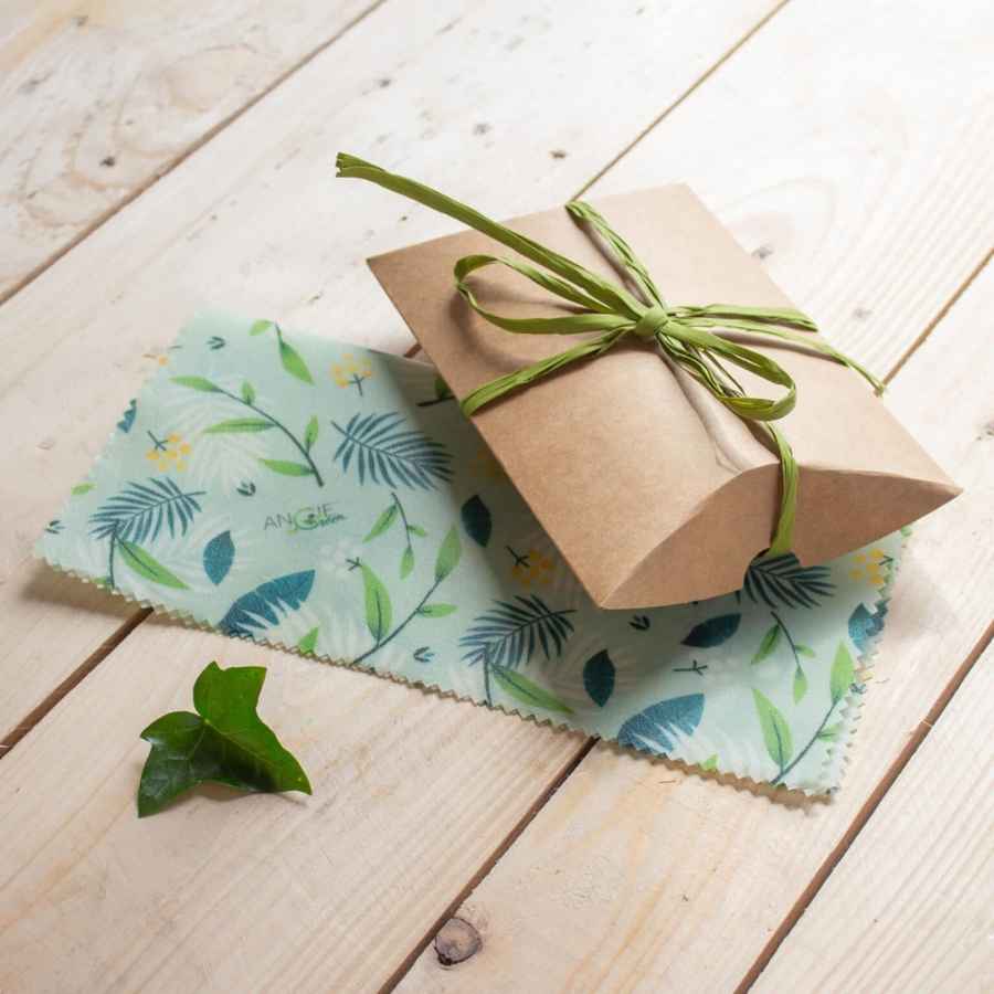 Packshot du bee wrap de la marque Angie Be Green avec son emballage, posés sur une table en bois