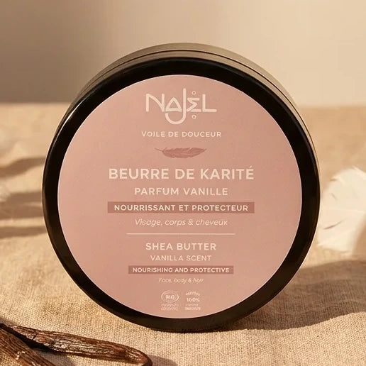 Beurre de Karité Vanille Najel 100g dans pot noir sur tissu beige avec gousses vanille