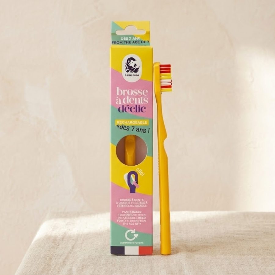 Une brosse à dent lamazuna pour enfant jaune rechargeable posée sur son étui