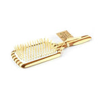 Une brosse à cheveux démêlante large de la marque Cap Bambou détourée sur fond blanc