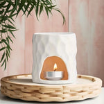 Brûle parfum en céramique blanc avec une bougie à l'intérieur 