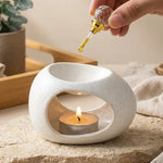 Brûleur de cire céramique blanc minimaliste avec diffuseur huiles essentielles et bougie allumée