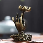 Un brûleur d'encens en cascade vu de dos, montrant la main de Bouddha et la fleur de lotus.