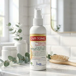 Capitonic spray anti-chute 125ml sur marbre avec accessoires coiffure et éléments botaniques