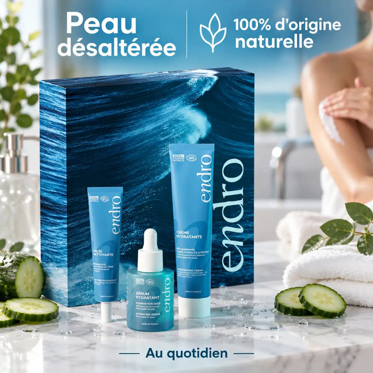 Coffret Vague d'Hydratation Endro : gelée nettoyante, sérum et crème visage bio posés sur un plan de marbre, avec concombre