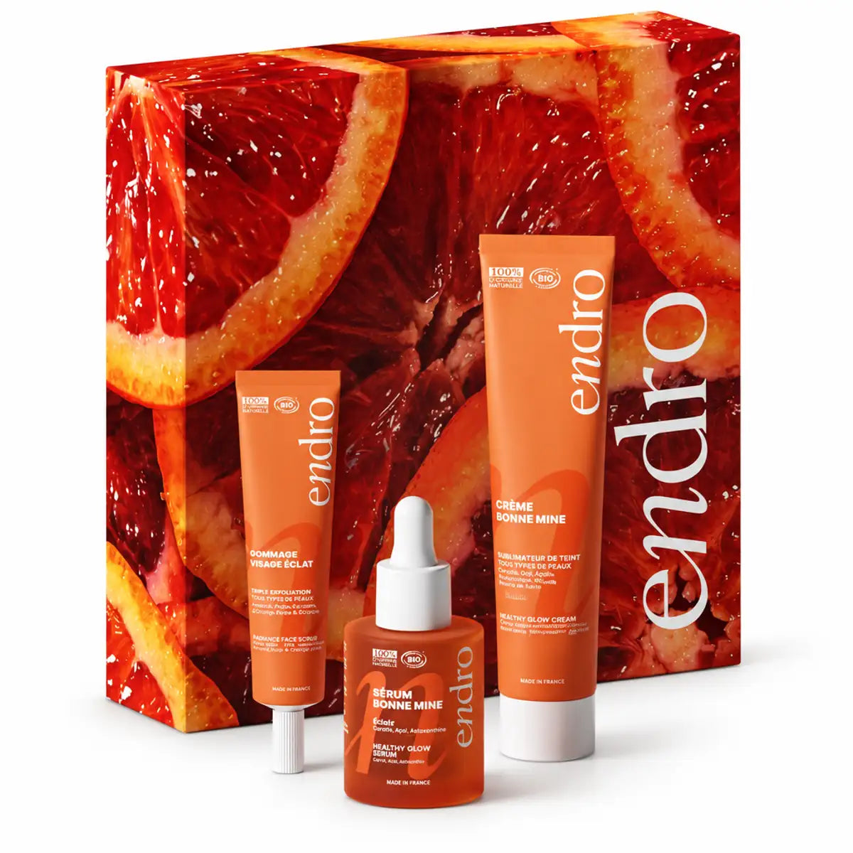 Coffret Zeste d'Éclat bio endro : gommage, sérum et crème visage orange sur fond blanc