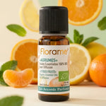 Flacon d'huile essentielle Agrumes Bio Florame 10ml avec agrumes frais et feuilles de menthe
