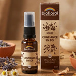 Spray Confiance en Soi Biofloral 20ml entouré de fleurs séchées sur bois naturel