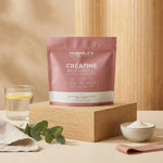 Créatine Glow AGE-WELL 300g Humble+ sur surface bois avec accessoires wellness