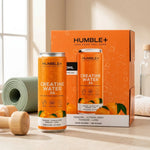 Créatine Water Humble+ 330ml saveur tangor-lime avec accessoires fitness sur fond beige