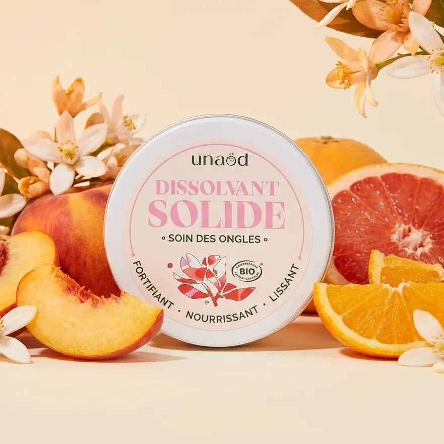 Dissolvant solide Unaöd 50ml rose avec agrumes et fleurs sur fond clair