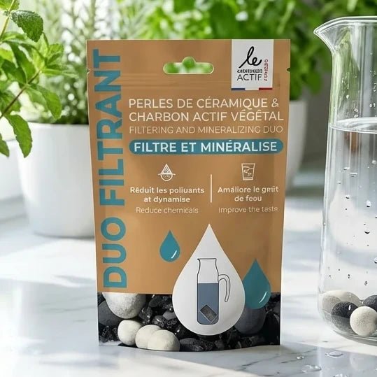 Duo Filtrant perles céramique charbon actif sur marbre avec verre d'eau filtrée