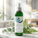 Eau capillaire Catalyons flacon vaporisateur 150ml verre vert dans salle de bain spa avec feuilles vertes