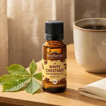 Fleur de Bach White Chestnut Bio en granules Biofloral, flacon ambre sur table en bois avec café et feuilles de marronnier