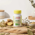 Haritaki bio 60 gélules Graine Sauvage sur surface bois avec herbes digestives et gingembre