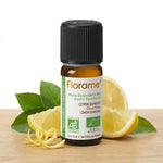 Huile essentielle citron bio Florame 10ml entourée de citrons frais et zeste