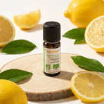 Huile essentielle citron zeste bio Florame 10ml avec citrons frais et feuilles vertes
