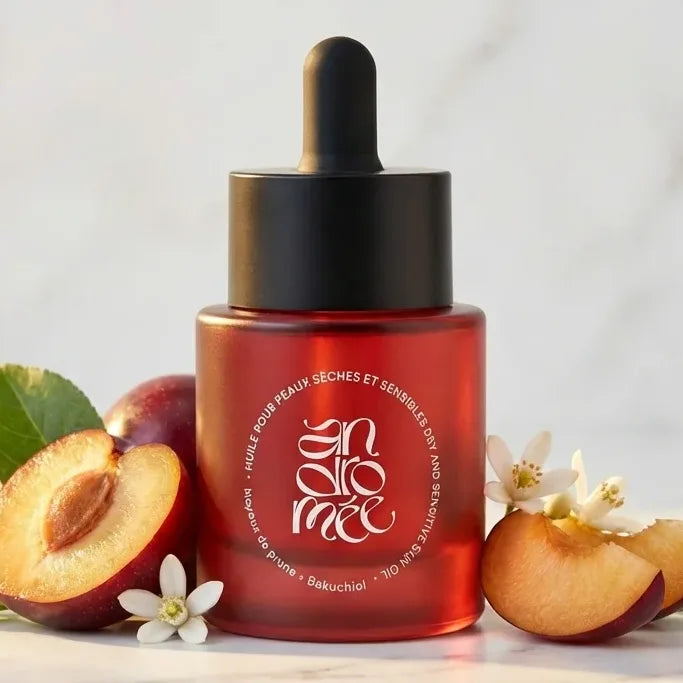 Huile Andromée 30ml pour peaux sèches sur marbre blanc avec fruits et éléments botaniques