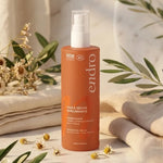Flacon Huile Sèche Sublimante Endro 100ml entouré de serviettes et plantes naturelles sur marbre blanc