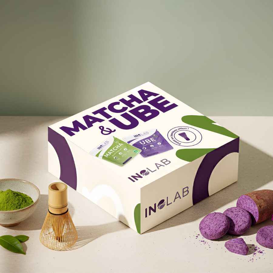 Un coffret de match et d'ube avec un fouet, un bol de poudre de matcha et de l'ube