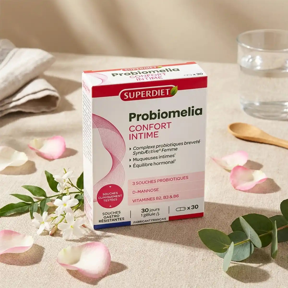 Boîte Probiomelia Confort Intime 30 gélules Superdiet sur fond beige avec fleurs botaniques