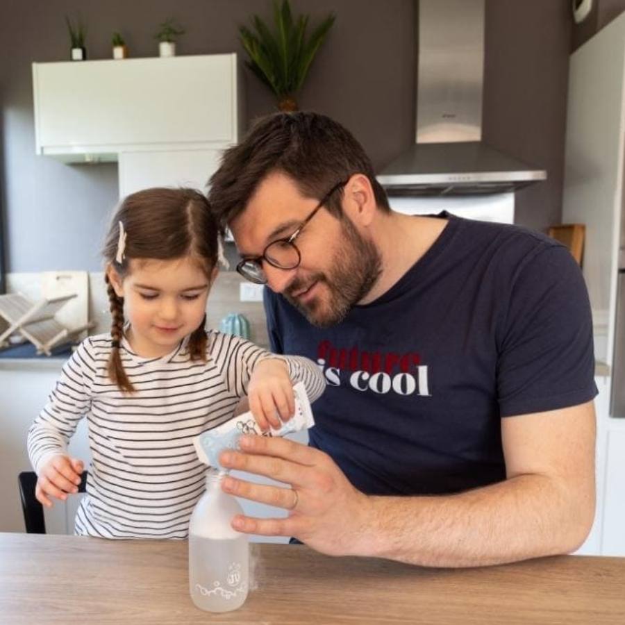 Père et fille remplissant un flacon avec la poudre de lavant pour les mains à diluer de la marque Pimpant