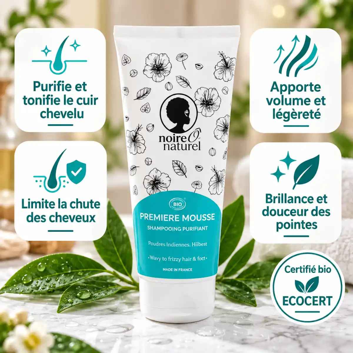 Shampoing Purifiant Bio Noire Ô Naturel 200 ml pour cheveux bouclés à frisés, tube turquoise sur marbre blanc, feuilles vertes et gouttes d'eau