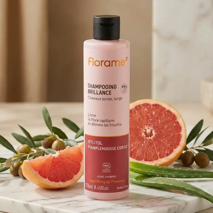 Shampooing Brillance Bio Florame 250ml avec agrumes et branche d'olivier sur marbre