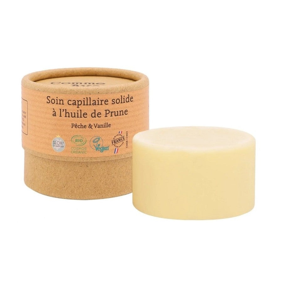Une boite kraft de 50 grammes de Soin Capillaire Solide à l'huile de Prune Pêche & Vanille Bio Comme avant