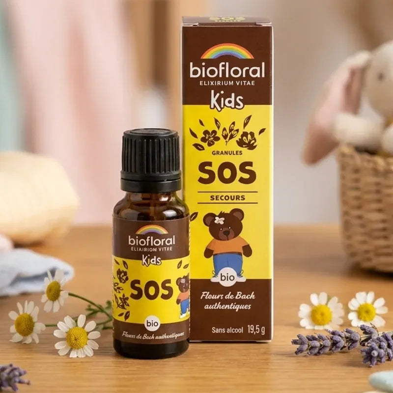 Granules Biofloral SOS Secours bio enfants 19,5g sur surface en bois avec fleurs naturelles