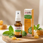 Spray buccal Propolia miel propolis menthe 20ml avec menthe fraîche et miel en arrière-plan
