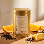 Thé noir Lueur d'Orange Bio Place des Thés dans boîte dorée avec tranches d'orange frais