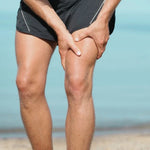 Homme appliquant une pression sur la cuisse, inconfort musculaire